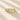 Gold ring with blue gemstones on a beige background