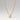 A gold beaded chain necklace featuring an oval pendant with a cutout design of a stylized face, shown against a neutral light gray background.