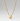 A gold beaded chain necklace featuring an oval pendant with a cutout design of a stylized face, shown against a neutral light gray background.