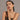 Woman wearing jewelry against a neutral background