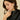 Woman wearing a ring and earrings with a neutral background