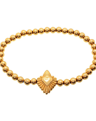 Gold bracelet made of small gold balls with a heart-shaped charm in the center, secured with a spring ring clasp
