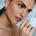 Gold ring featuring a heart-shaped design with zircon
